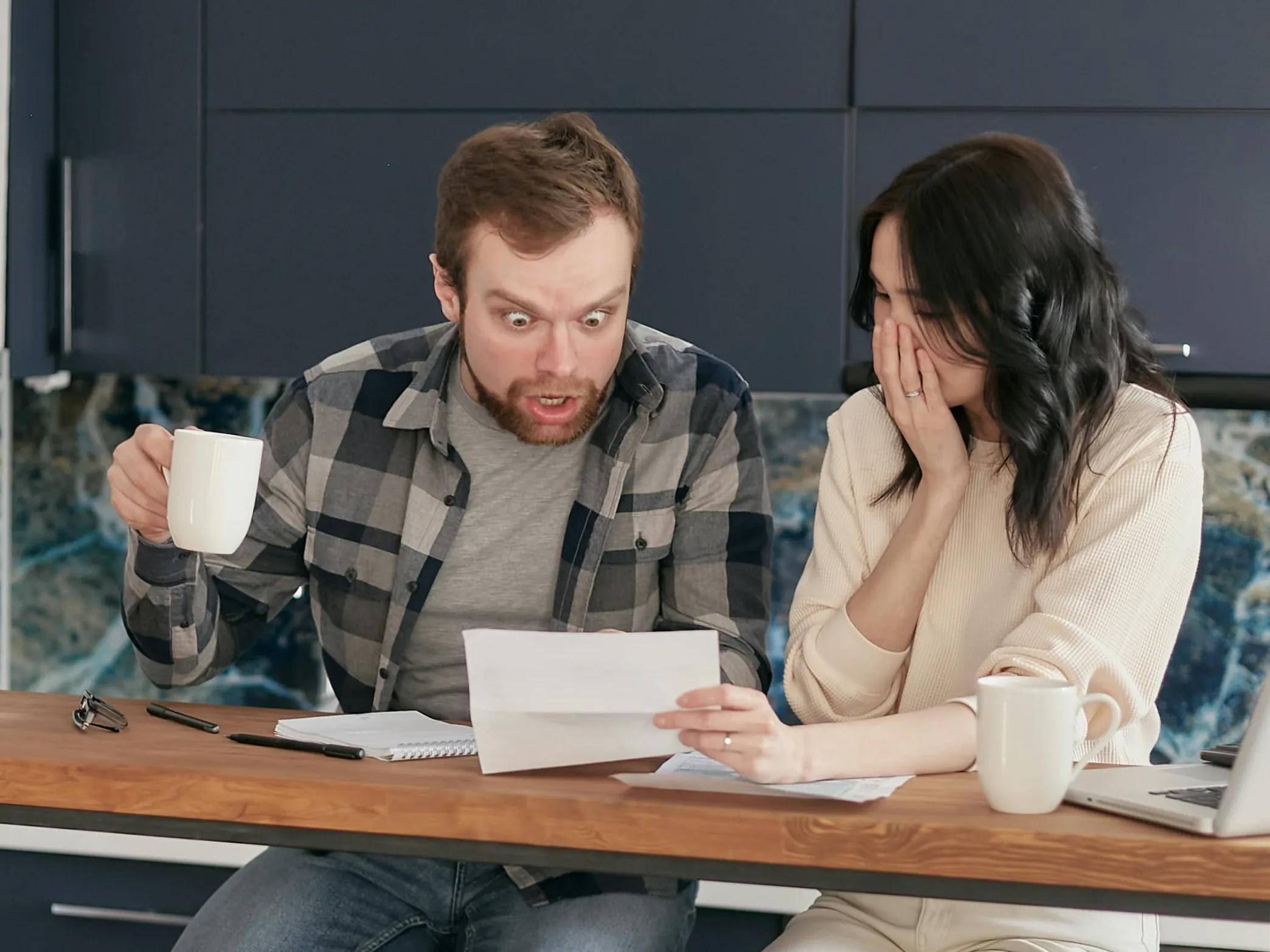 a couple discussing finances at a desk