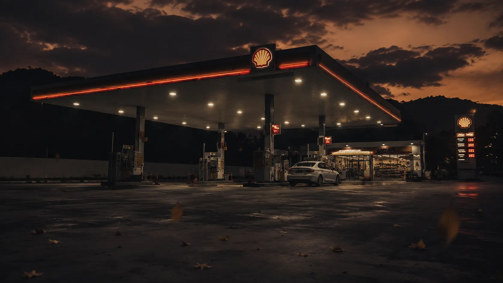 A quiet petrol station forecourt at dusk, price board glowing against a dark amber sky, cinematic and tense