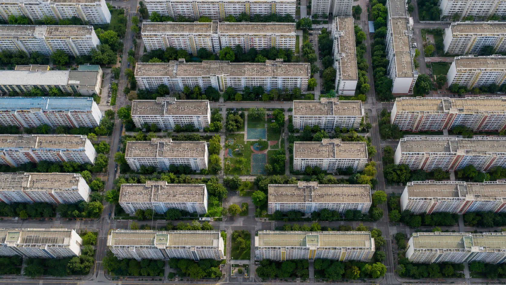 Aerial grid of dense, orderly public housing blocks in Singapore, showing a highly structured urban layout