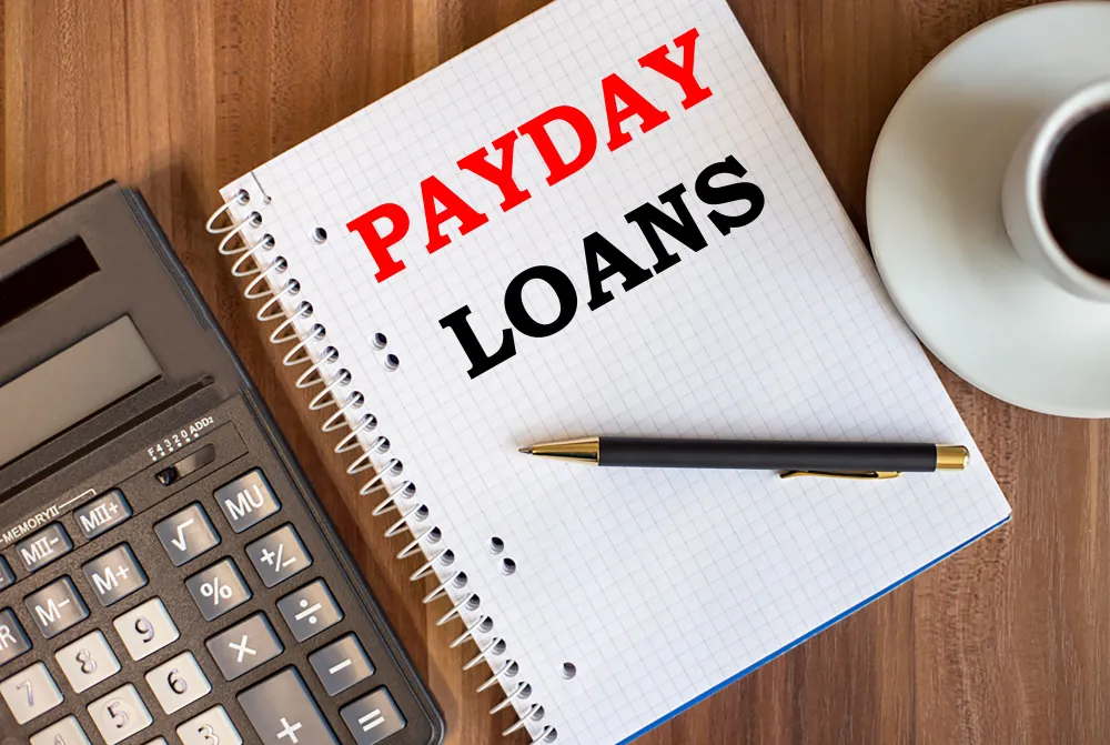 Payday Loans text stamped on a grid paper notebook